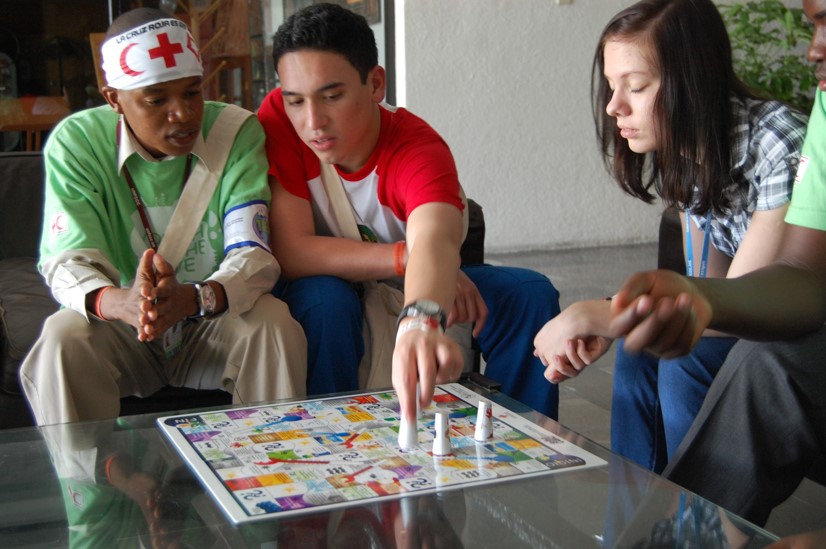 Youths playing a climate change awareness/education game (based around the Snakes & Ladders game) developed by the Colombian Red Cross.